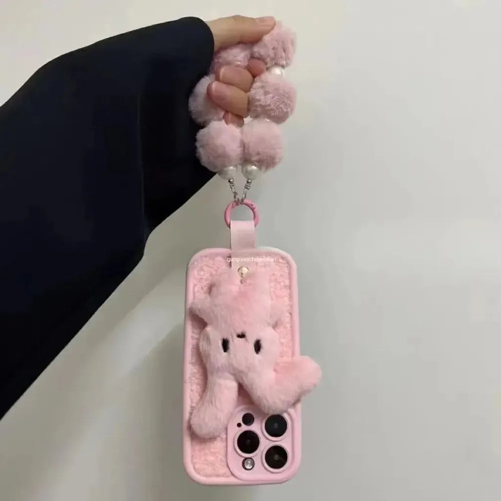 Bunny plush pink foldable-eared rabbit phone case with pink wrist strap.